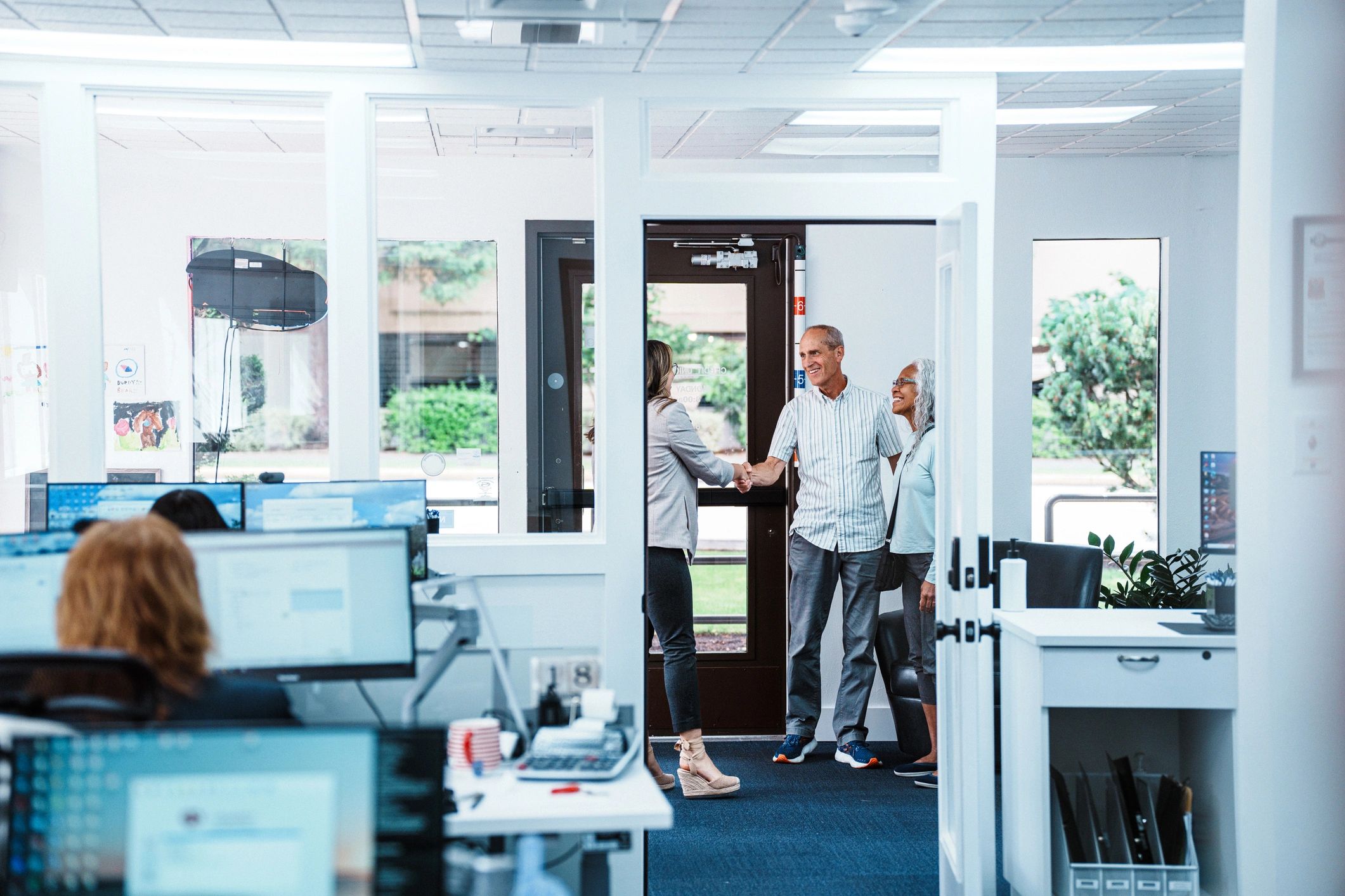 Professional service team welcoming clients in a corporate environment